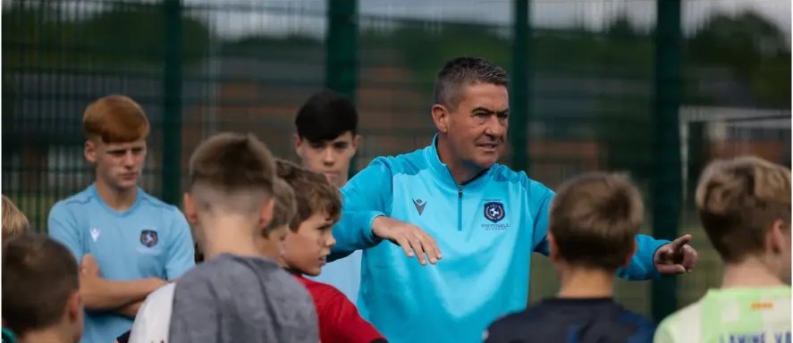 Marc Kenny talking to camp players
