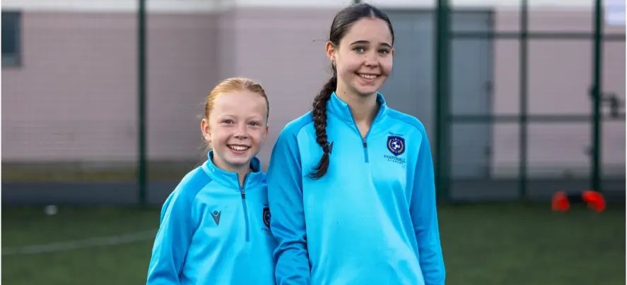 Two smiling camp players