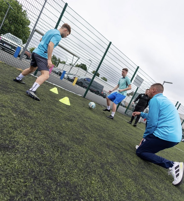 Coach and players in a drill