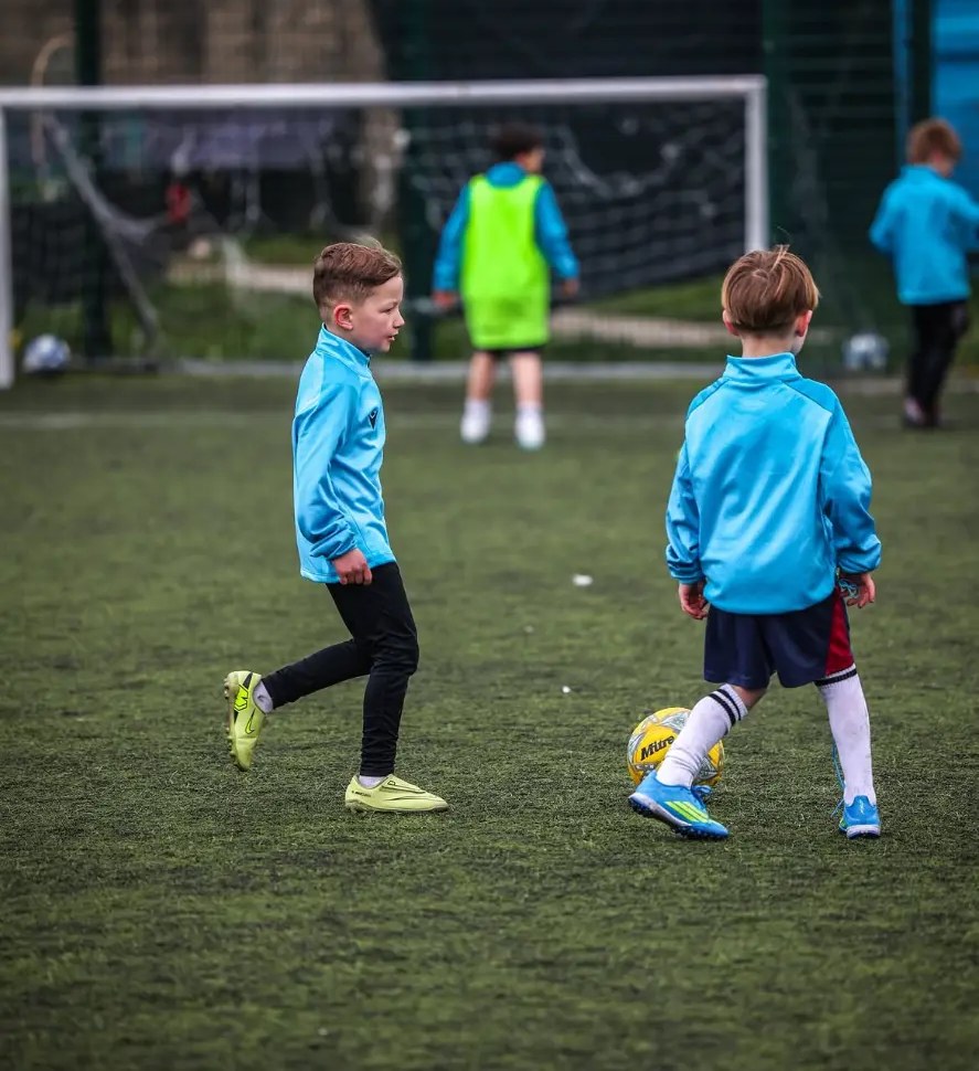 Two young players dribbling
