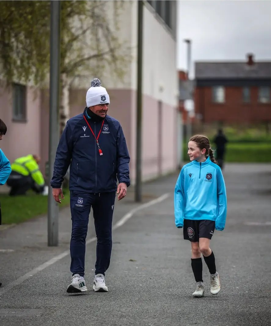 Marc Kenny walking with a player