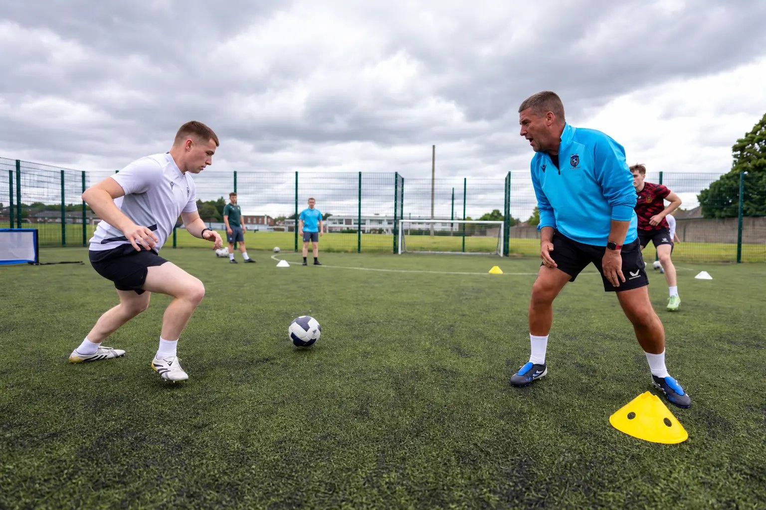 Marc Kenny coaching a player during a training session