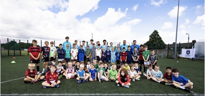 Group photo of academy players on the pitch