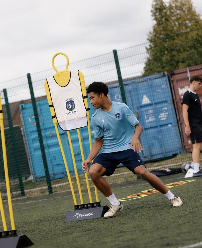 Player dribbling past a training mannequin